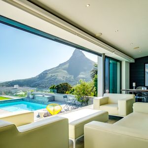 Patio lounge seating and mountain views; AMAZING HELY - Camps Bay