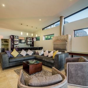 Living room with indoor braai; SEA AND ROCK VILLA - Camps Bay