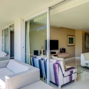 Living room with balcony access; AMANI VILLA - Mouille Point