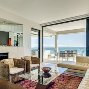 Lounge with TV and fireplace; BALI SUITE - Camps Bay