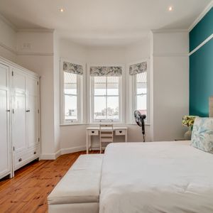 Main bedroom with bay window; RED HOUSE - Sea Point